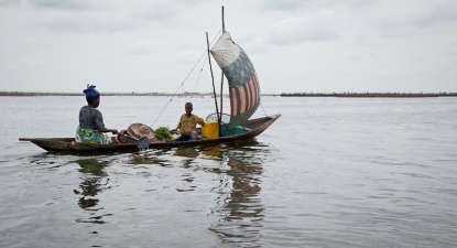 Woman and child in dugout canoe, Ganvie Village, Benin. [NO MODEL RELEASE]
